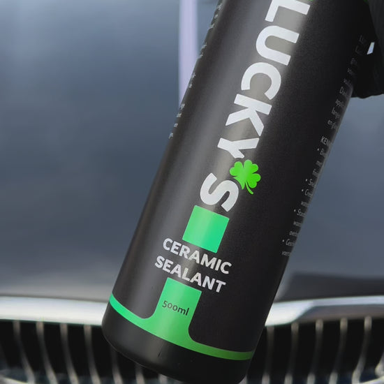 Demonstration of Lucky’s Ceramic Sealant – long-lasting paint protection with over 3 months of durability. One side of the car hood is treated with the ceramic sealant using an applicator glove, while the other side remains untreated. When water is poured over the surface, the treated side clearly repels water and provides protection, whereas the untreated side retains water. Perfect for long-term hydrophobic protection of car paint.
